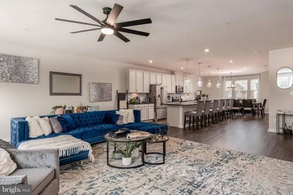 a living room with furniture and kitchen view