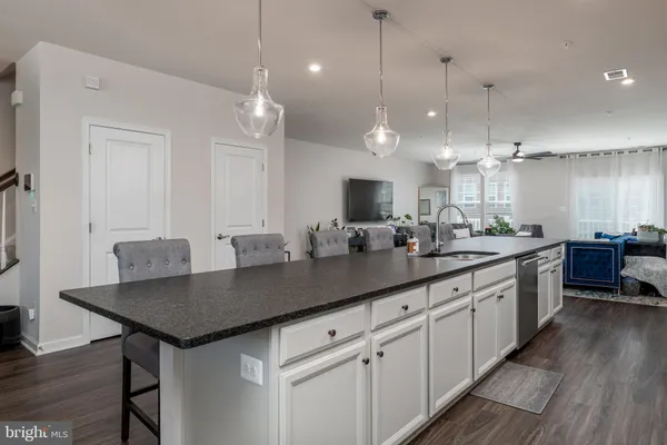a kitchen with kitchen island white cabinets and a sink