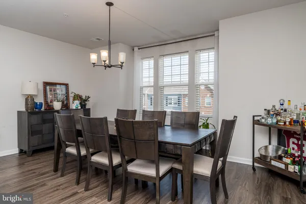 a view of a dining room with furniture wooden floor and chandelier