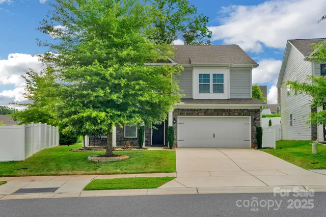 a front view of a house with a yard and a garage