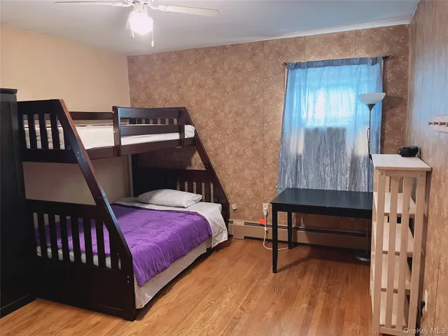 a bedroom with furniture and a window