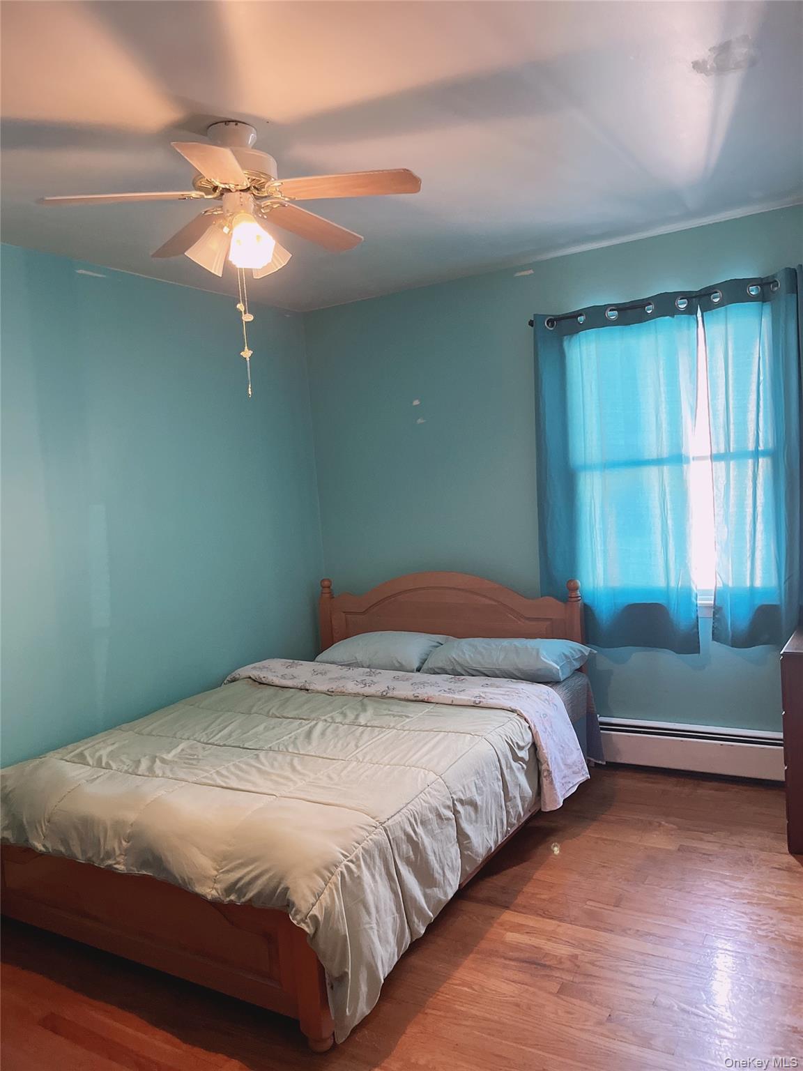 225 Monhagen Avenue Middletown, NY 10940 - Photo 13 of 19 a bedroom with a bed and a chandelier