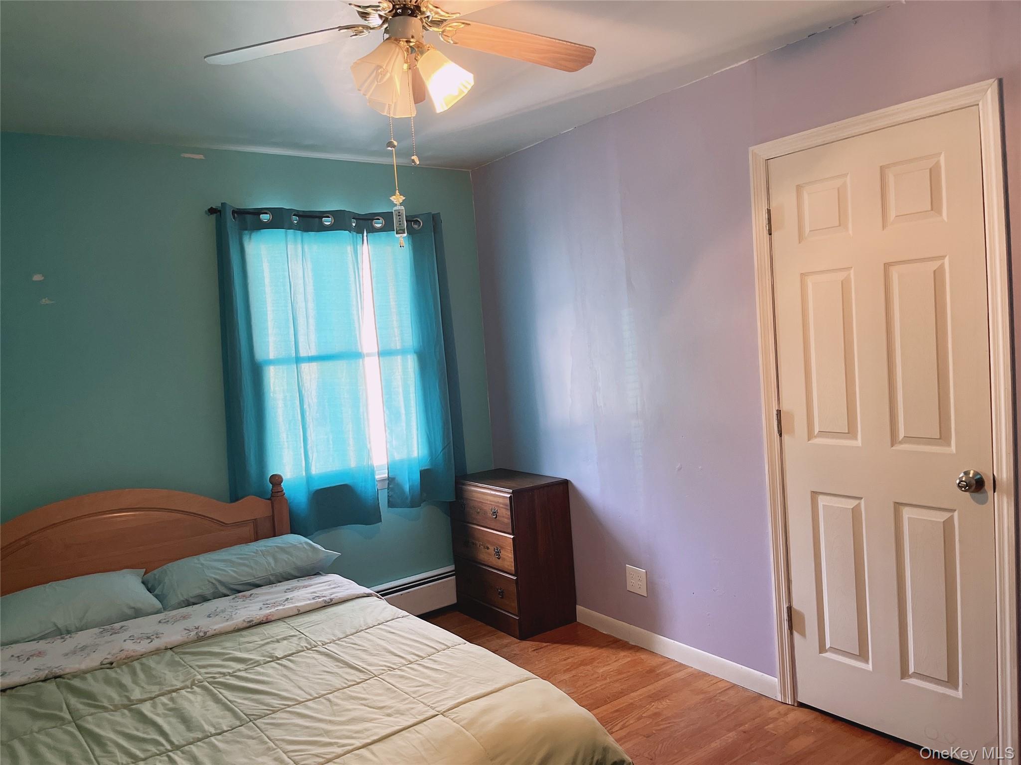 225 Monhagen Avenue Middletown, NY 10940 - Photo 15 of 19 a bedroom with a bed and a chandelier