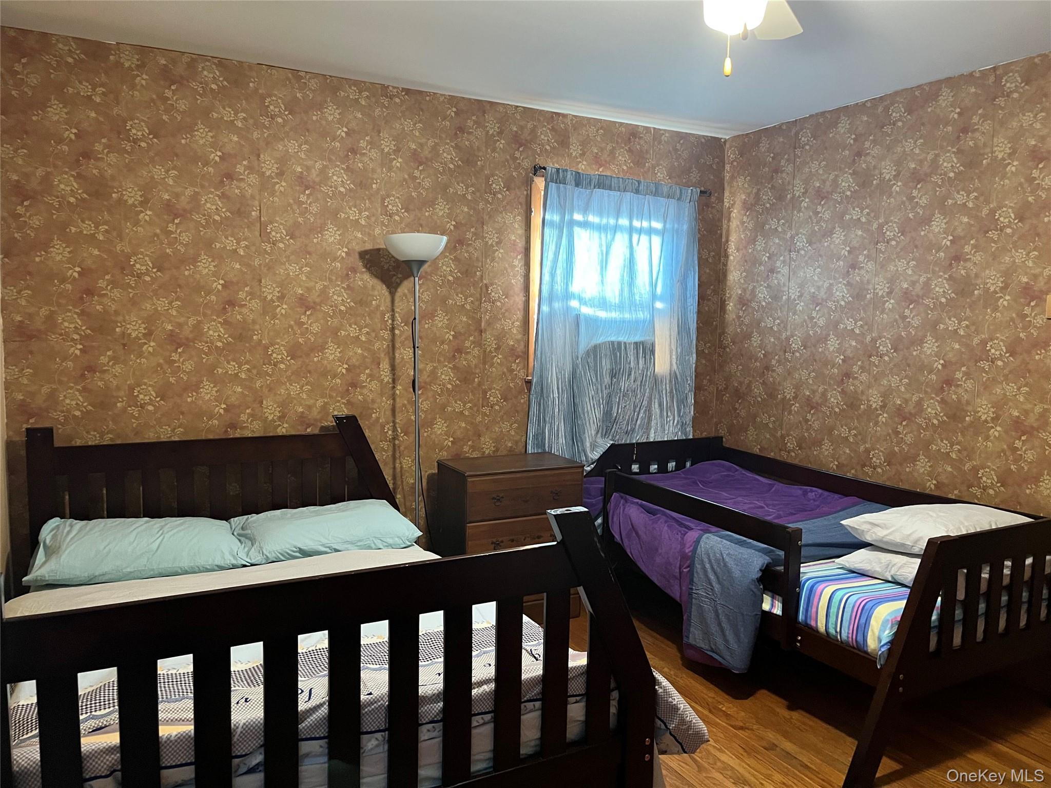 225 Monhagen Avenue Middletown, NY 10940 - Photo 19 of 19 a bedroom with a bed and wooden floor