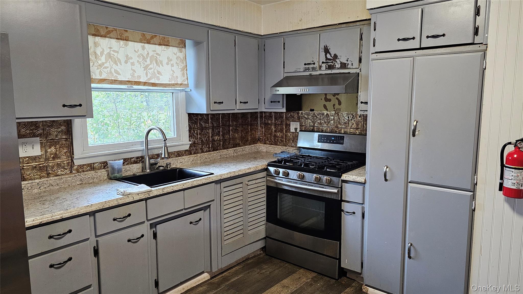 225 Monhagen Avenue Middletown, NY 10940 - Photo 3 of 19 a kitchen with stainless steel appliances granite countertop a sink stove and refrigerator