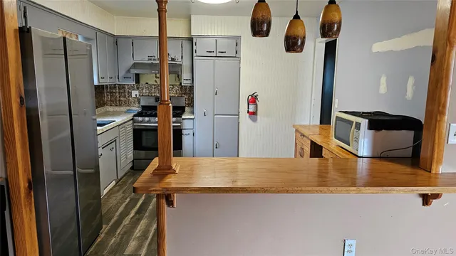 a kitchen with stainless steel appliances granite countertop a refrigerator and a stove