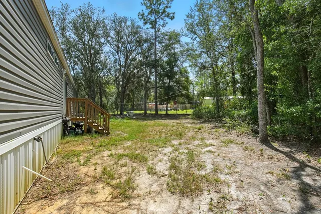 a view of outdoor space with deck and yard