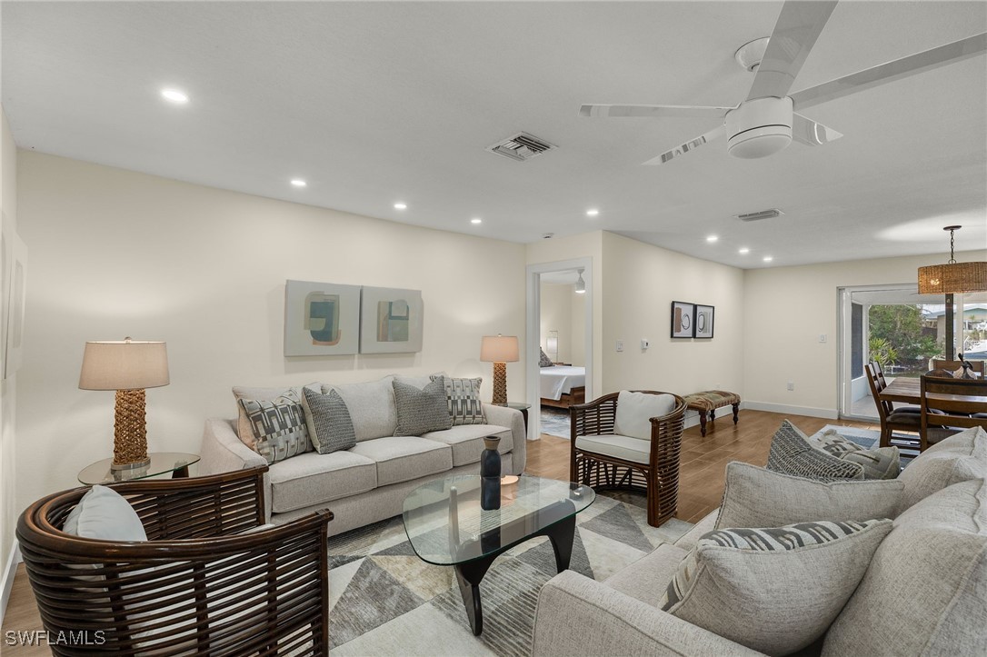 5869 Pine Tree Drive Sanibel, FL 33957 - Photo 11 of 30 a living room with furniture and a lamp