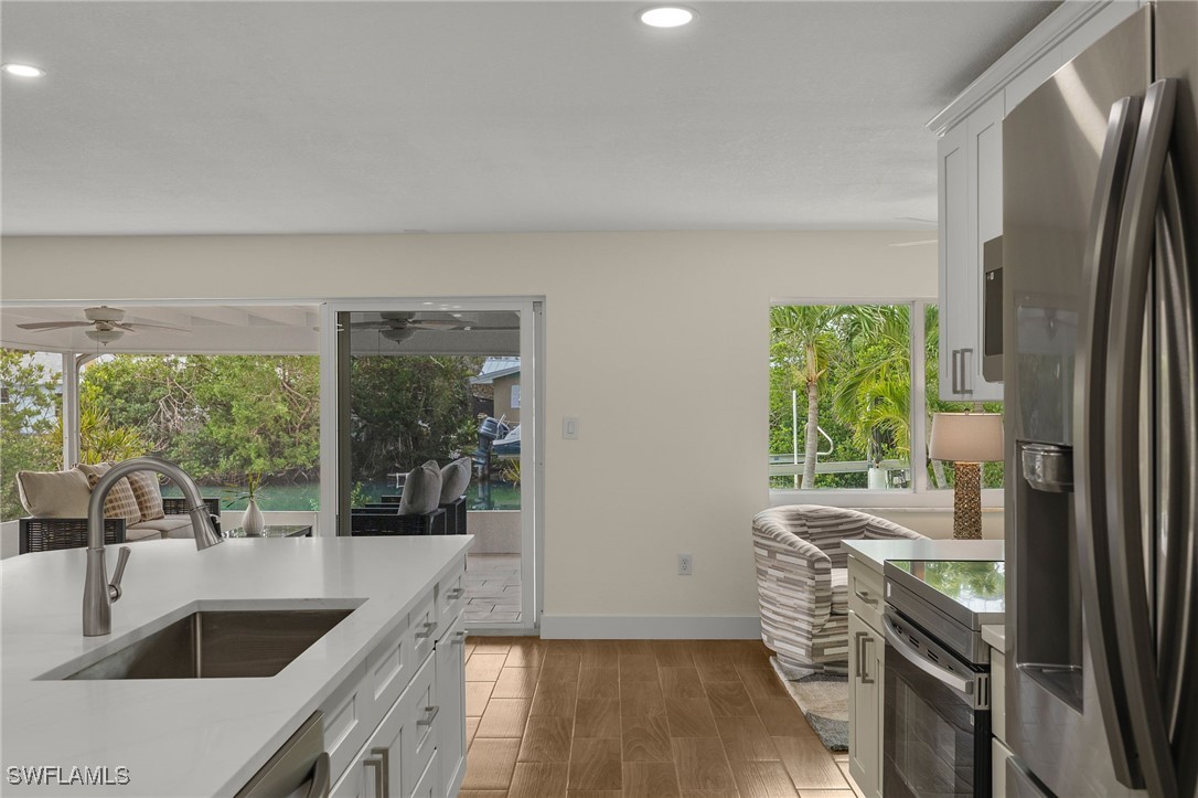 5869 Pine Tree Drive Sanibel, FL 33957 - Photo 16 of 30 a kitchen with a sink and a refrigerator