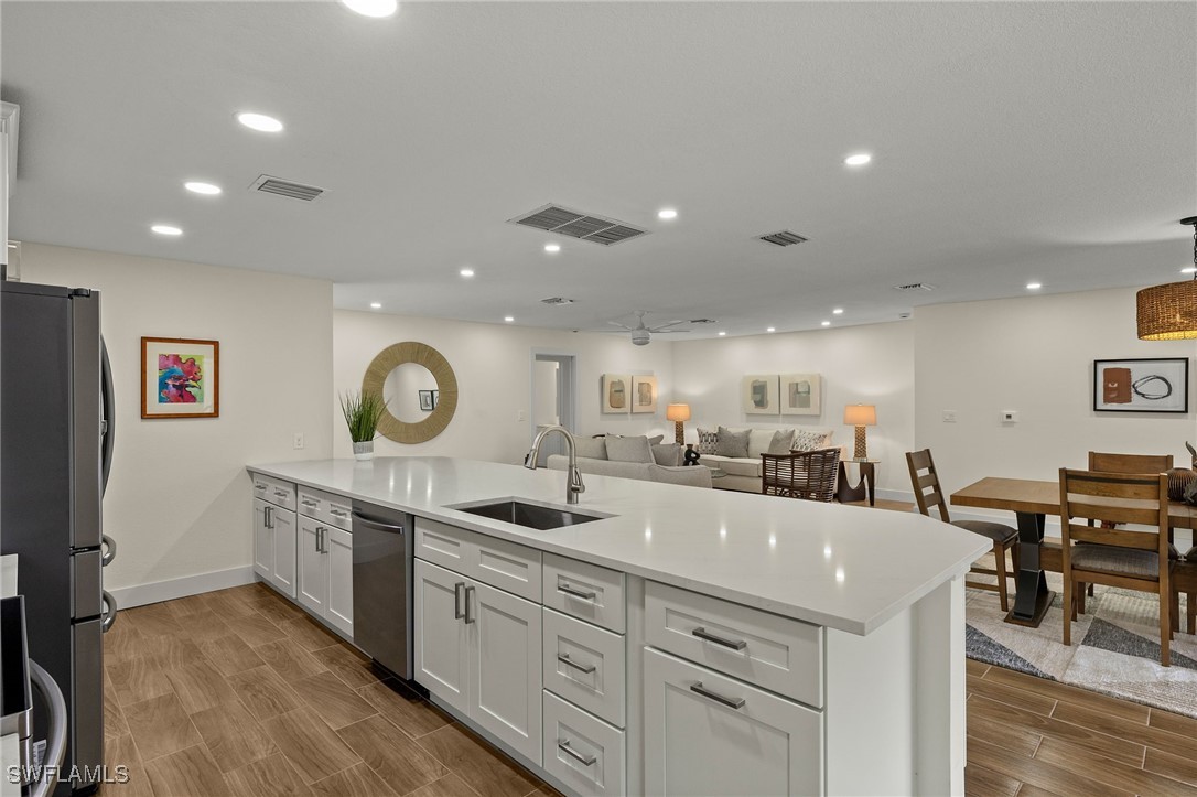 5869 Pine Tree Drive Sanibel, FL 33957 - Photo 17 of 30 a large kitchen with a large counter top appliances and cabinets