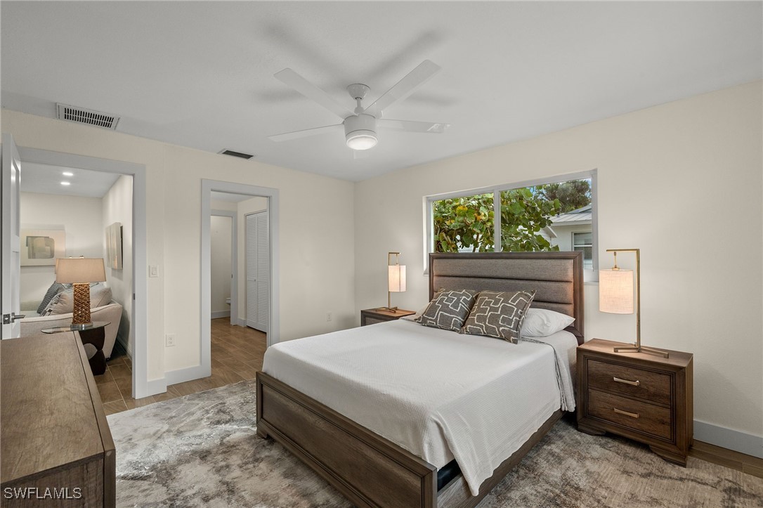 5869 Pine Tree Drive Sanibel, FL 33957 - Photo 21 of 30 a bedroom with a bed and a large mirror