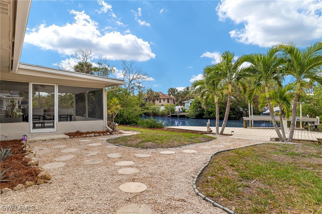 5869 Pine Tree Drive Sanibel, FL 33957 - Photo 6 of 30 a view of a house with backyard and sitting area