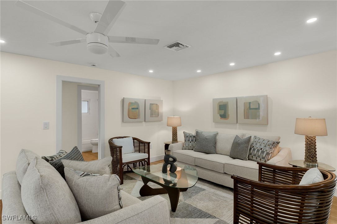 5869 Pine Tree Drive Sanibel, FL 33957 - Photo 10 of 30 a living room with furniture and a lamp