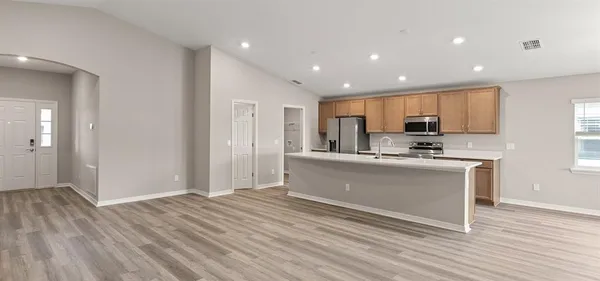 a kitchen with stainless steel appliances granite countertop a refrigerator sink and cabinets