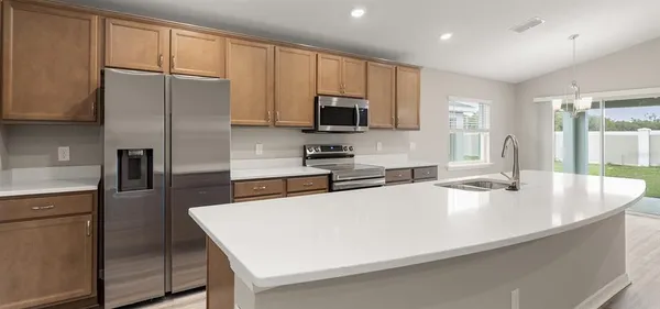 a kitchen with stainless steel appliances a microwave sink and refrigerator