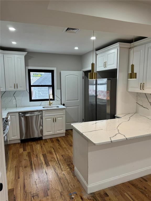 a large kitchen with stainless steel appliances a large counter top