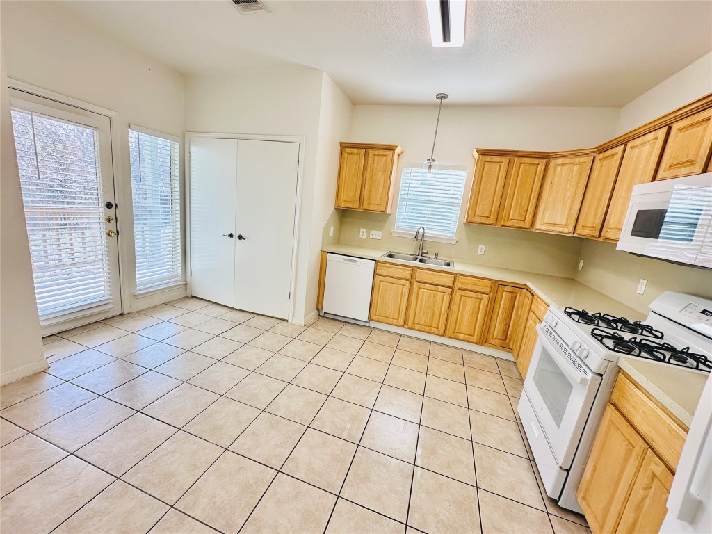 6301 Crumley Lane Austin, TX 78741 - Photo 11 of 39 a kitchen with stainless steel appliances a sink and cabinets
