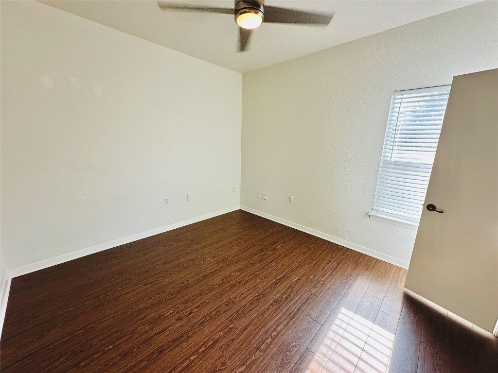 6301 Crumley Lane Austin, TX 78741 - Photo 22 of 39 wooden floor in an empty room with a window