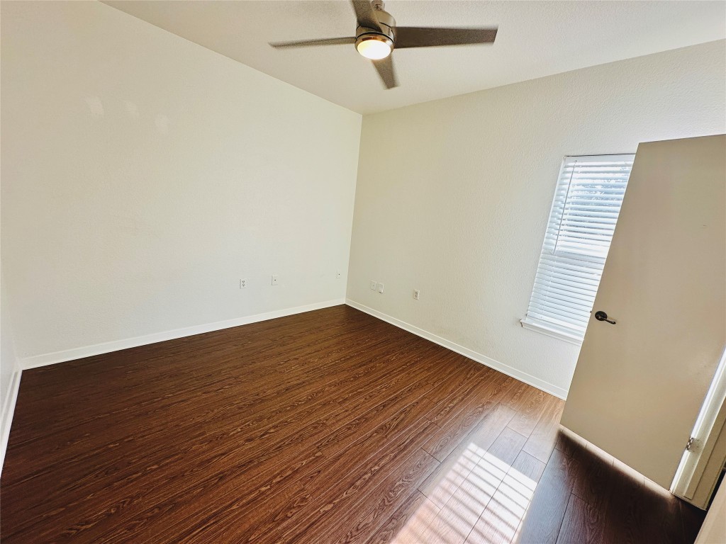 6301 Crumley Lane Austin, TX 78741 - Photo 24 of 39 an empty room with wooden floor and windows