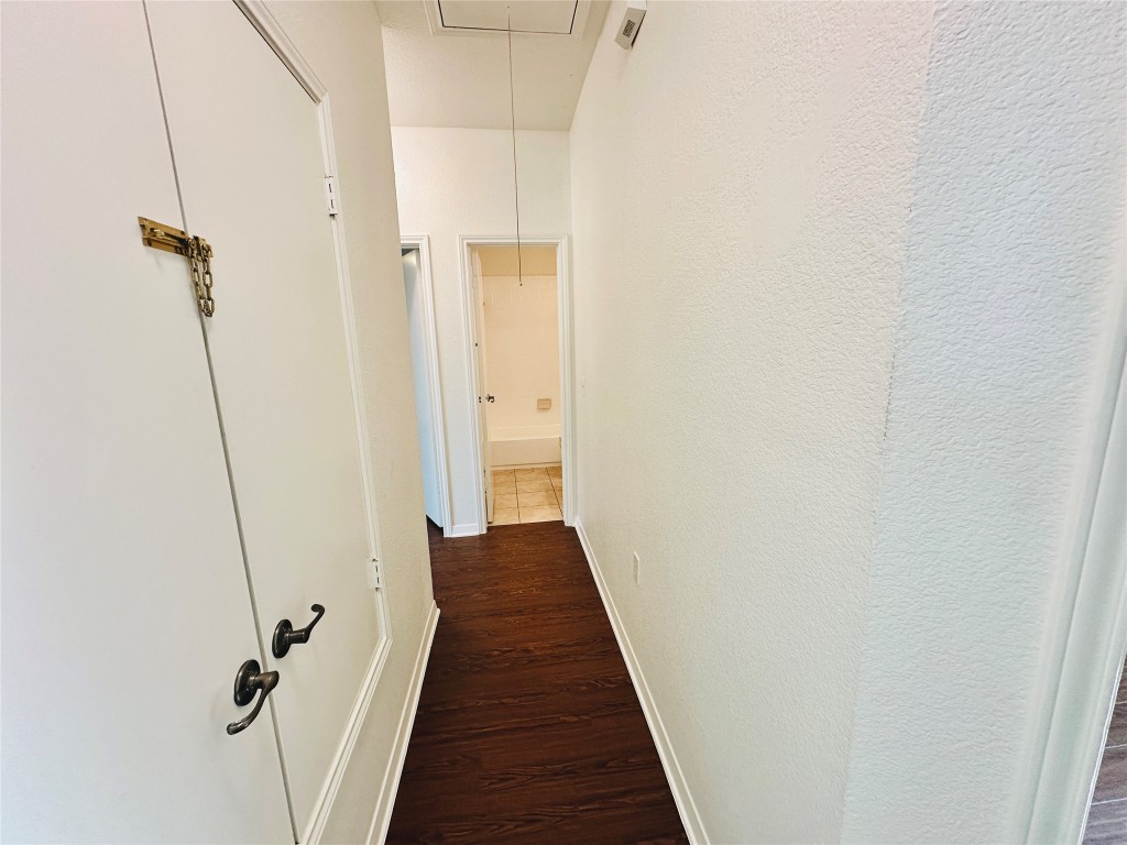 6301 Crumley Lane Austin, TX 78741 - Photo 27 of 39 a view of a hallway with wooden floor and staircase