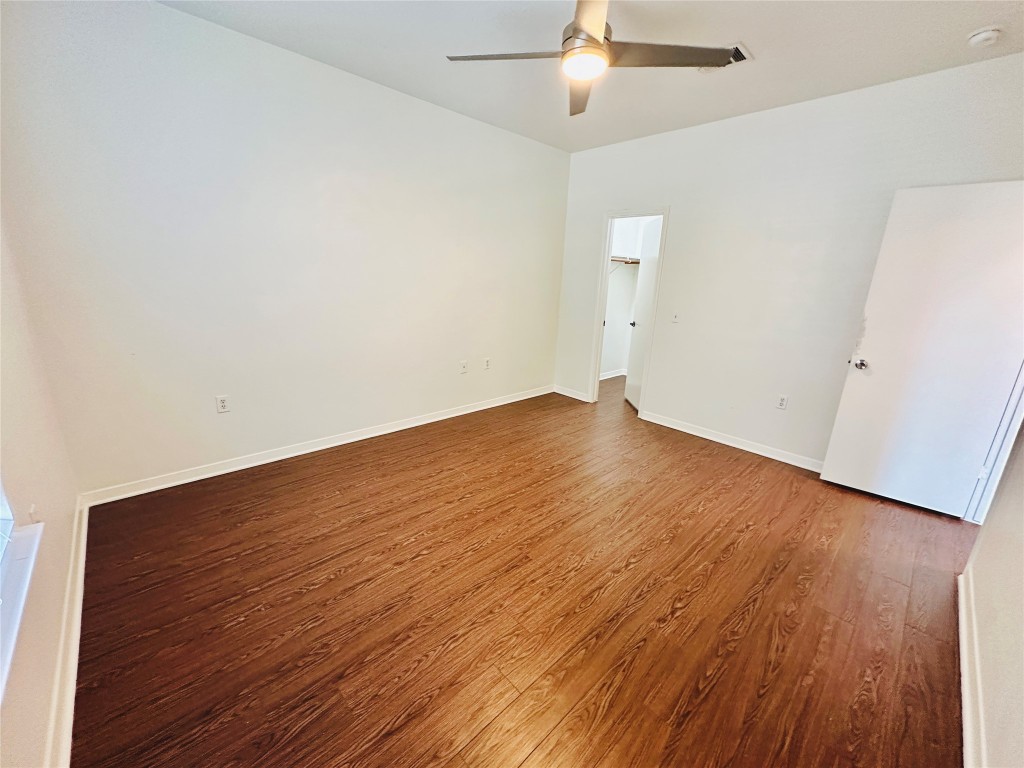 6301 Crumley Lane Austin, TX 78741 - Photo 32 of 39 an empty room with wooden floor and windows