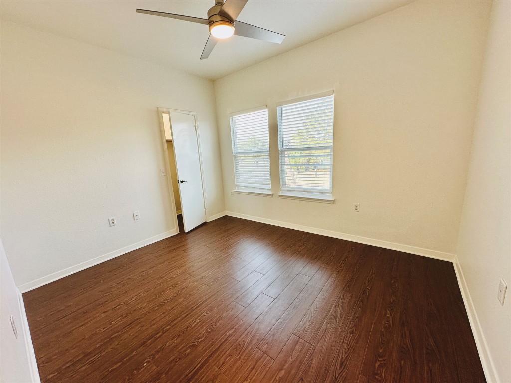 6301 Crumley Lane Austin, TX 78741 - Photo 36 of 39 an empty room with wooden floor fan and windows