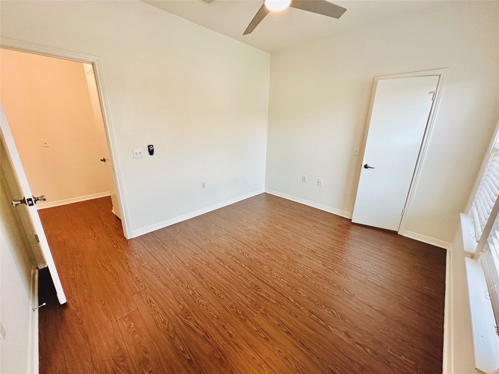6301 Crumley Lane Austin, TX 78741 - Photo 37 of 39 an empty room with wooden floor and windows