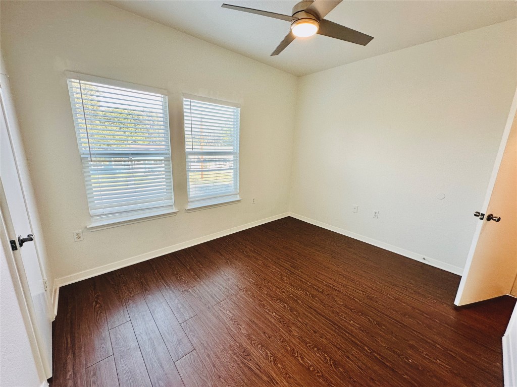 6301 Crumley Lane Austin, TX 78741 - Photo 38 of 39 an empty room with wooden floor and windows
