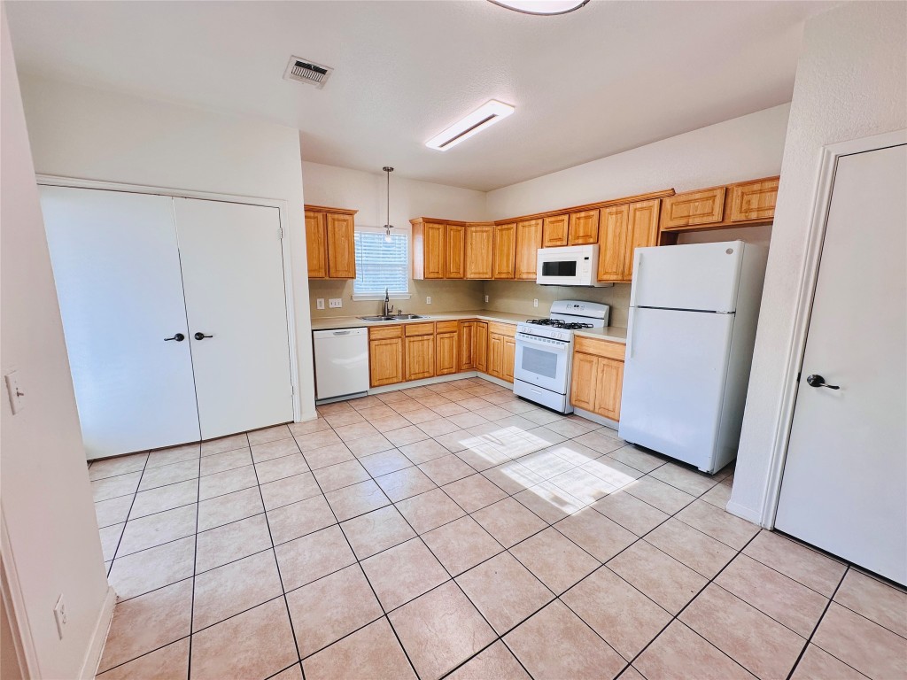 6301 Crumley Lane Austin, TX 78741 - Photo 8 of 39 a kitchen with granite countertop cabinets and steel stainless steel appliances