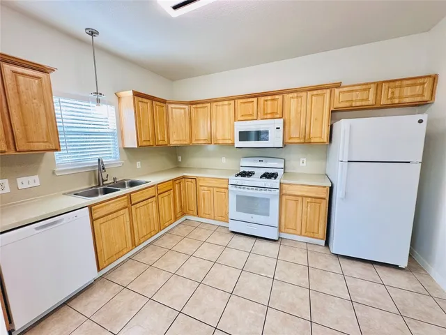a kitchen with a sink a stove and refrigerator