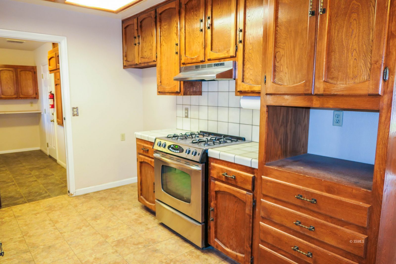 812 South Sunset Street Ridgecrest, CA 93555 - Photo 13 of 40 a kitchen with stainless steel appliances granite countertop a stove and a cabinet