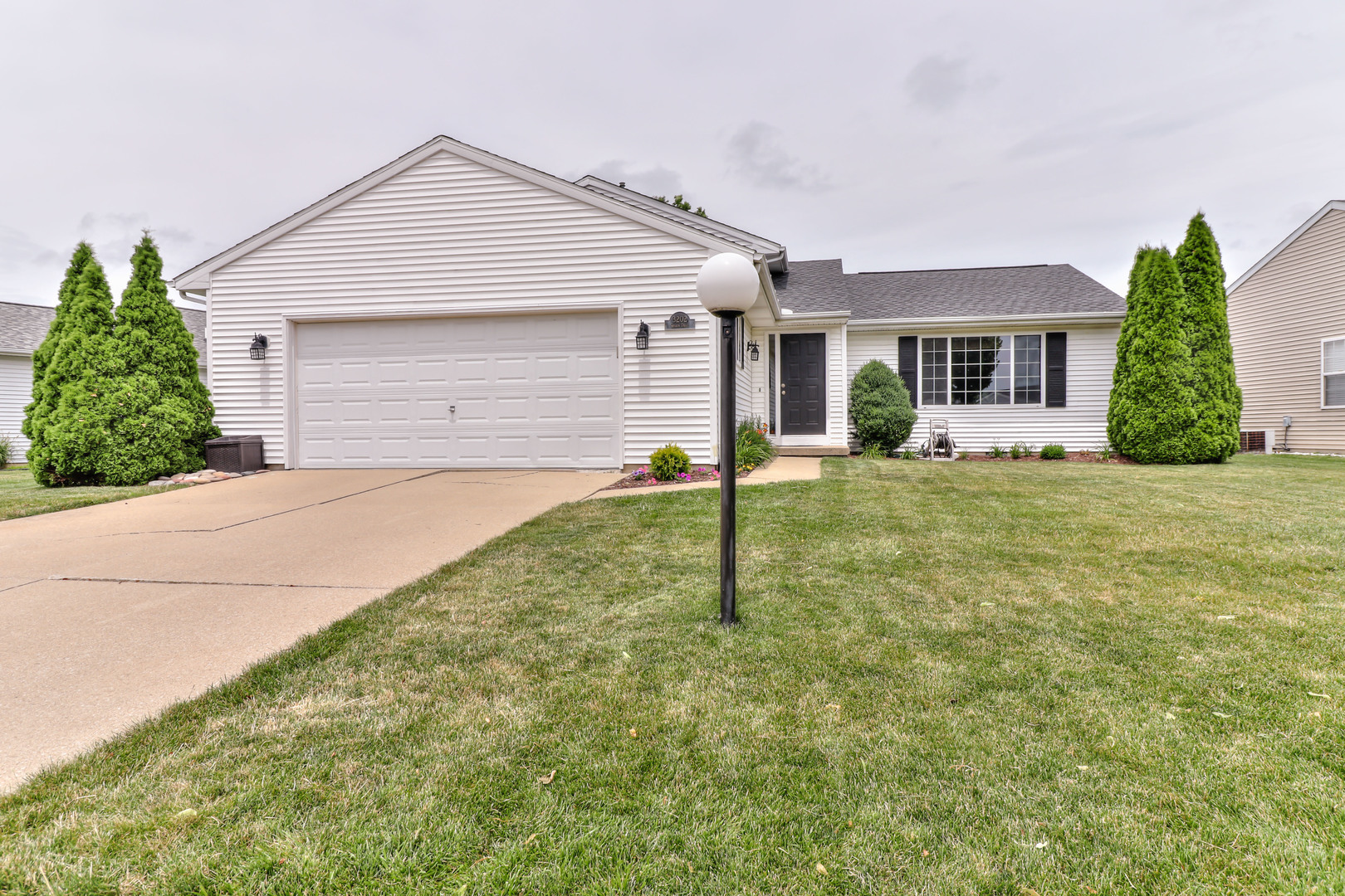 3202 Sharon Drive Champaign, IL 61822 - Photo 2 of 37 a front view of a house with a yard and garage