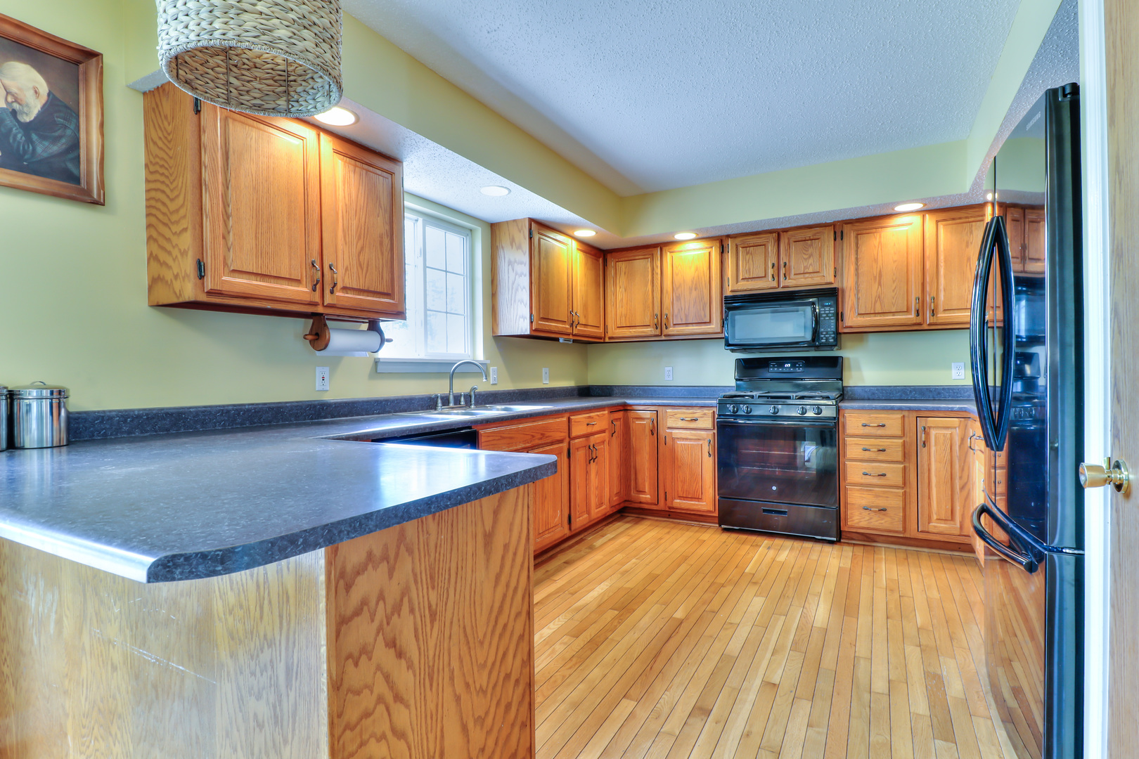 3202 Sharon Drive Champaign, IL 61822 - Photo 15 of 37 a kitchen with stainless steel appliances granite countertop a sink a stove and a wooden cabinets