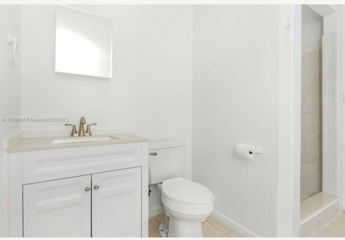 1115 Hernando Street, Unit A Fort Pierce, FL 34949 - Photo 18 of 18 a bathroom with a sink toilet and vanity