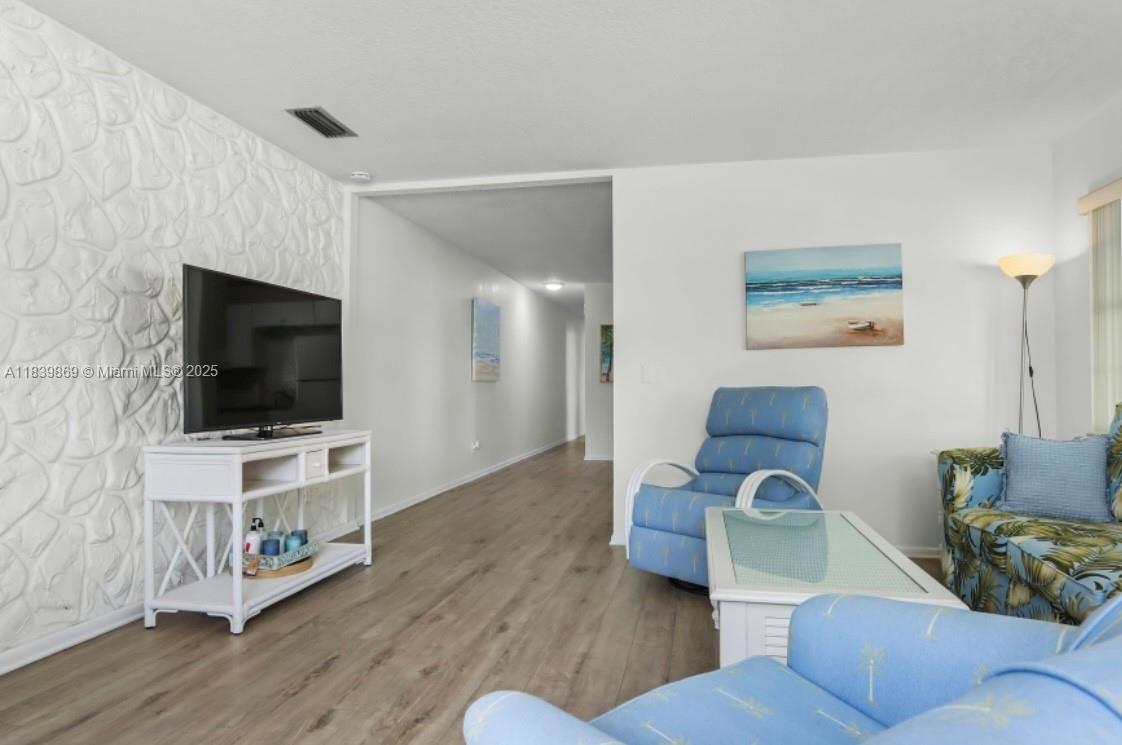 1115 Hernando Street, Unit A Fort Pierce, FL 34949 - Photo 10 of 18 a living room with furniture and a flat screen tv