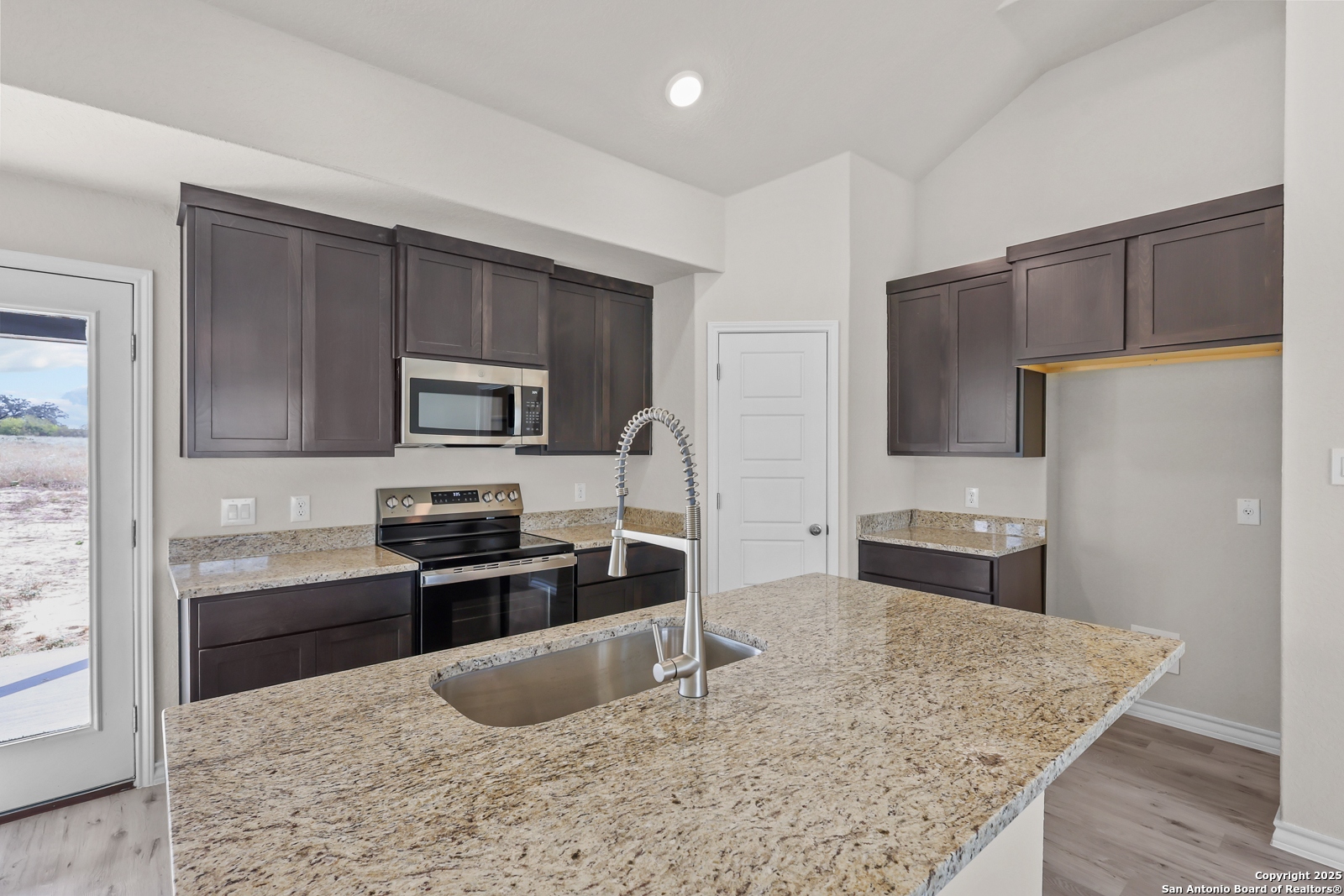 30 Log Cabin Way Poteet, TX 78065 - Photo 13 of 47 a kitchen with granite countertop a refrigerator stove and sink