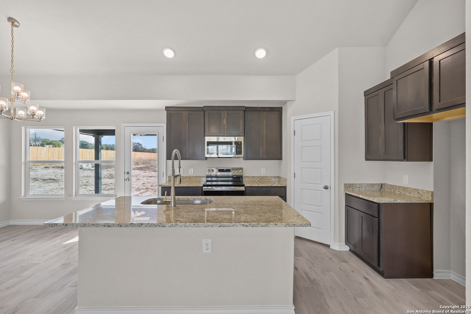 30 Log Cabin Way Poteet, TX 78065 - Photo 14 of 47 a kitchen with stainless steel appliances granite countertop a stove and a sink