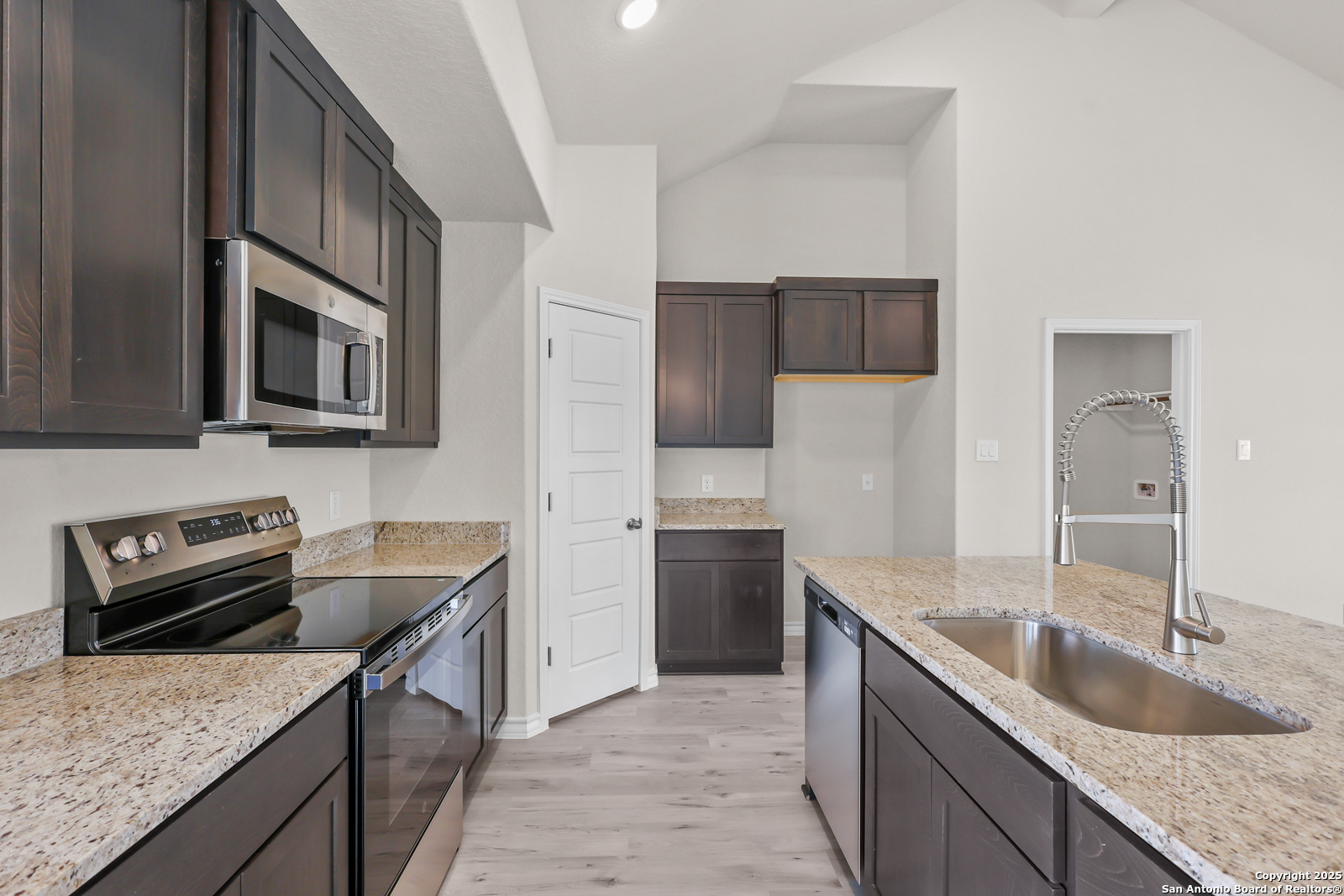 30 Log Cabin Way Poteet, TX 78065 - Photo 16 of 47 a kitchen with stainless steel appliances granite countertop a sink stove and refrigerator