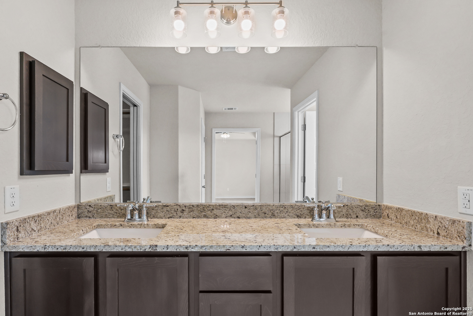 30 Log Cabin Way Poteet, TX 78065 - Photo 22 of 47 a bathroom with a granite countertop sink and a large mirror