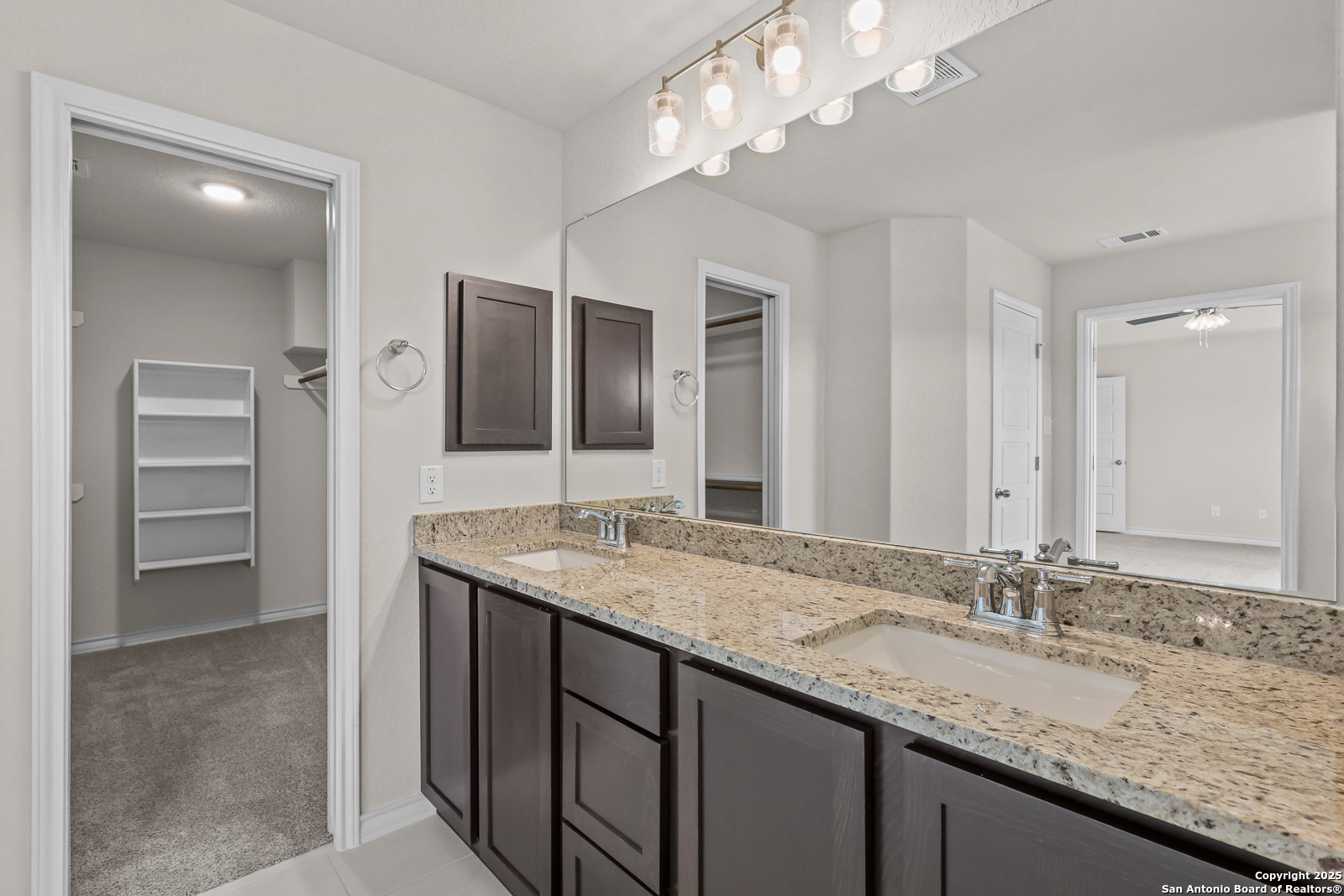 30 Log Cabin Way Poteet, TX 78065 - Photo 23 of 47 a bathroom with a granite countertop double vanity sink and a mirror