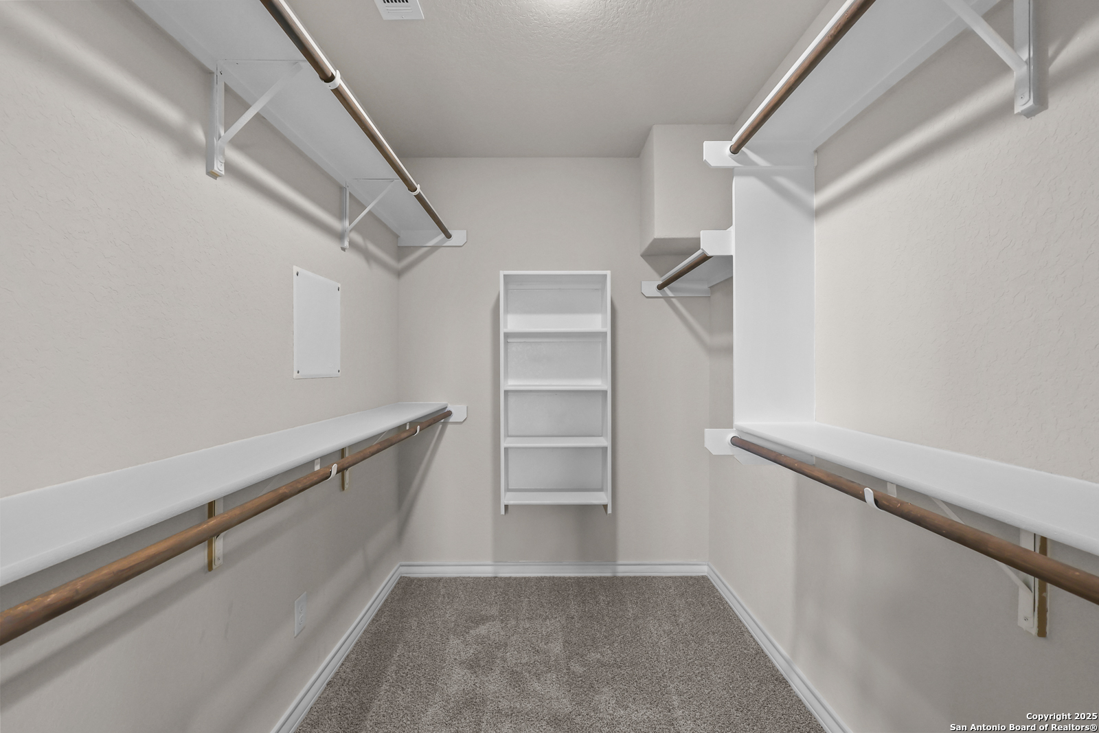 30 Log Cabin Way Poteet, TX 78065 - Photo 26 of 47 a view of walk in closet with empty racks