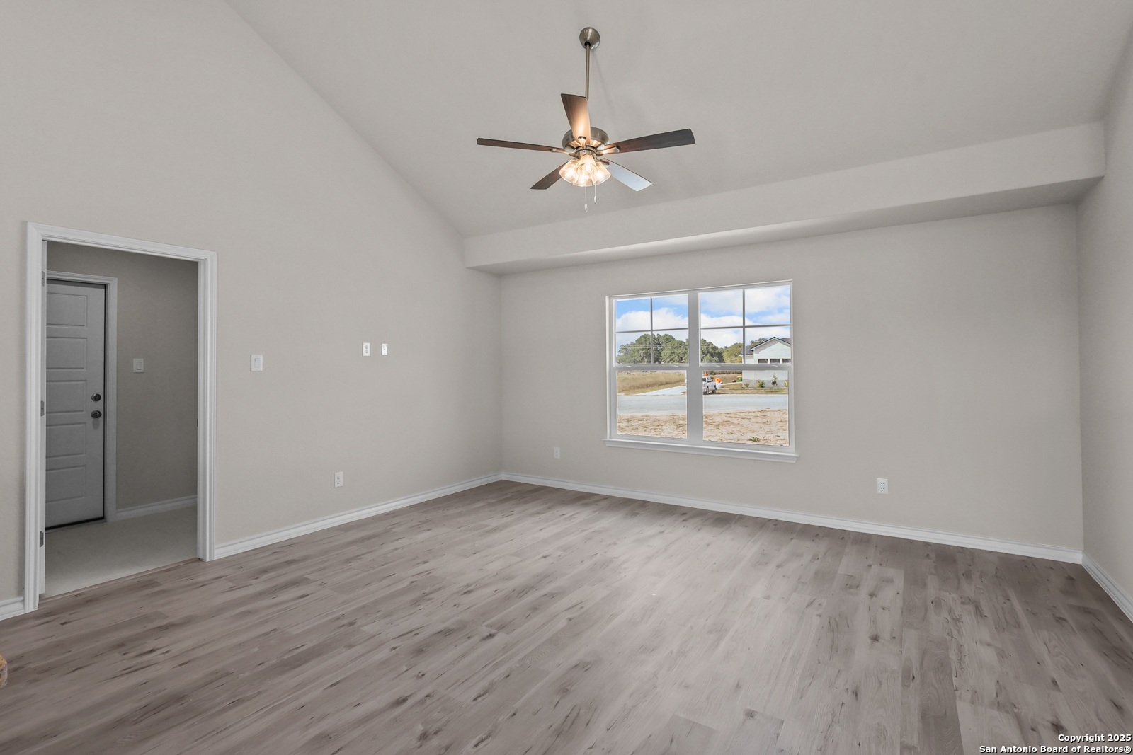 30 Log Cabin Way Poteet, TX 78065 - Photo 8 of 47 a view of an empty room with wooden floor and a window