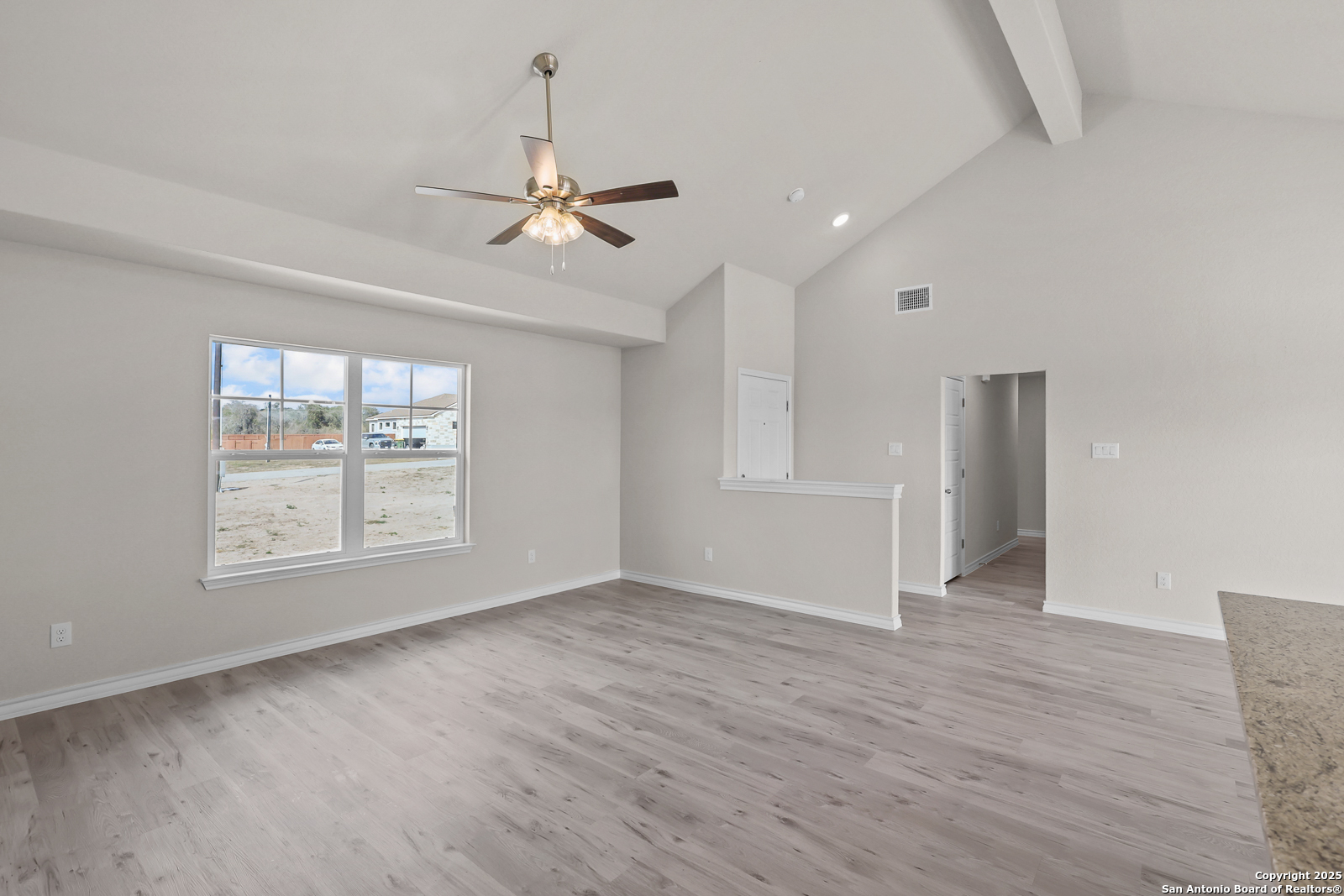 30 Log Cabin Way Poteet, TX 78065 - Photo 9 of 47 wooden floor in an empty room with a window