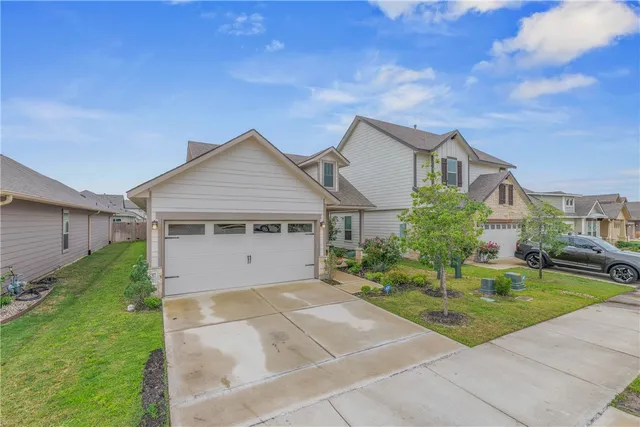 a front view of house with yard and green space