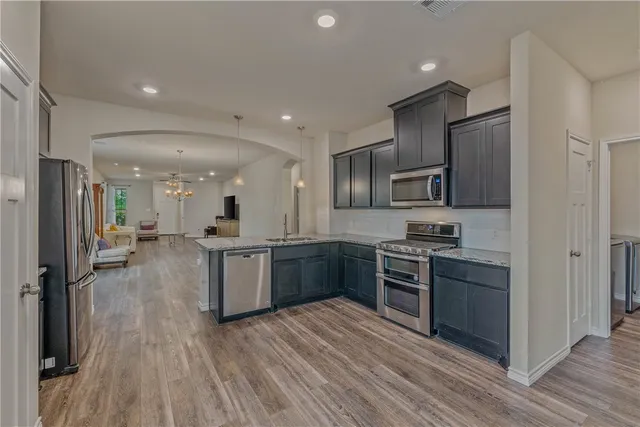 a bathroom with a granite countertop sink a toilet and a large mirror