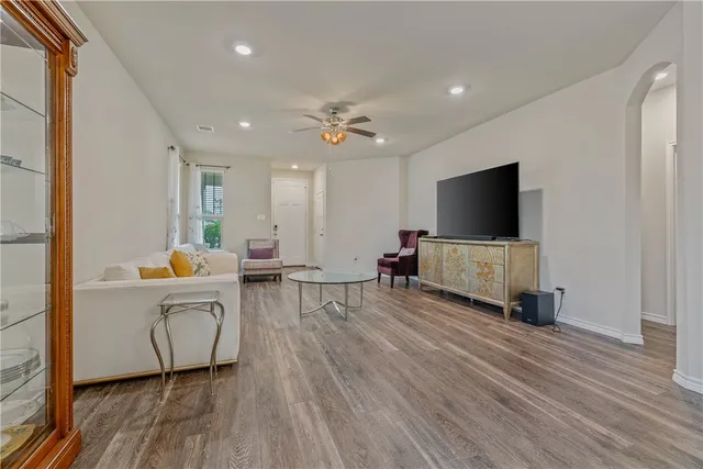 a living room with furniture and wooden floor
