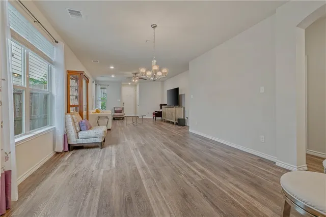 a living room with furniture and a chandelier