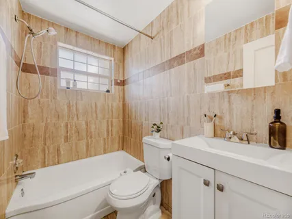 a bathroom with a sink a toilet and shower curtain
