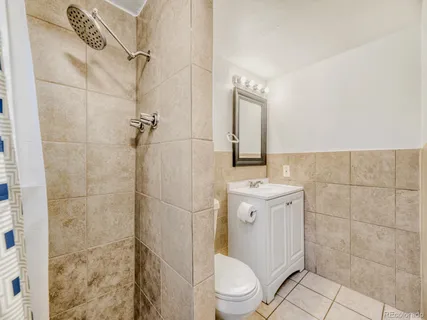 a white toilet sitting next to a bathroom sink