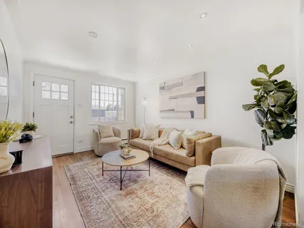 a living room with furniture potted plant and a window